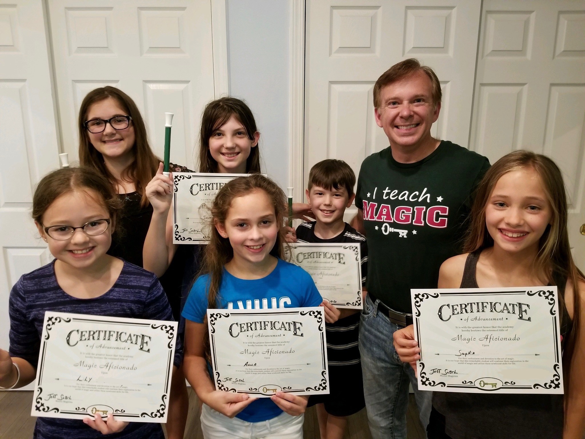 Students at their graduation showcase holding certificates